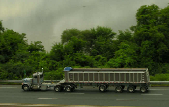 Daycab with dump trailer passing Cootes Paradise Hamilton, Ontario, Canada