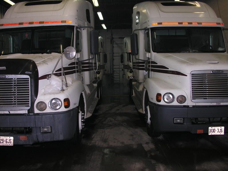 Freightliner Highway tractors in the shop thawing out from the cold and snow 