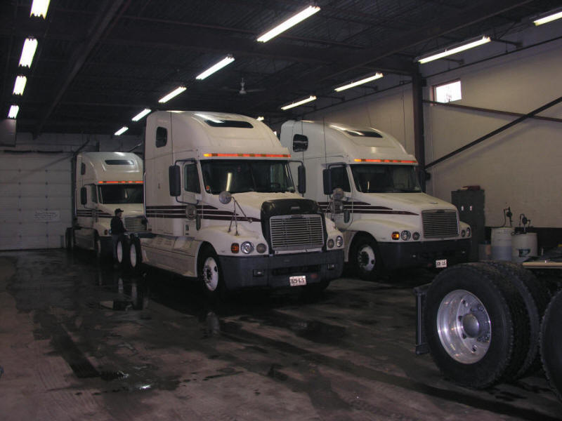 Freightliner Highway units hiding from the snow in the shop