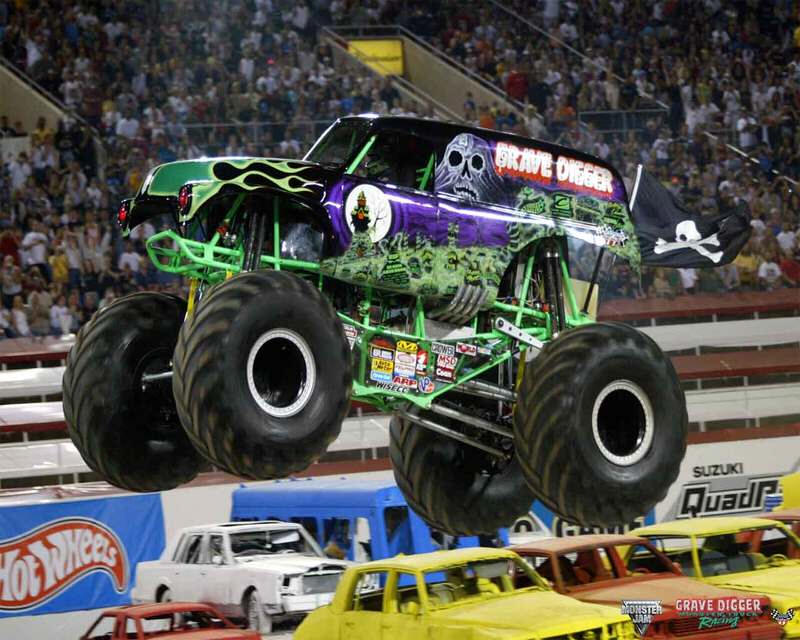 Grave Digger Monster Truck flying over cars with full house watching