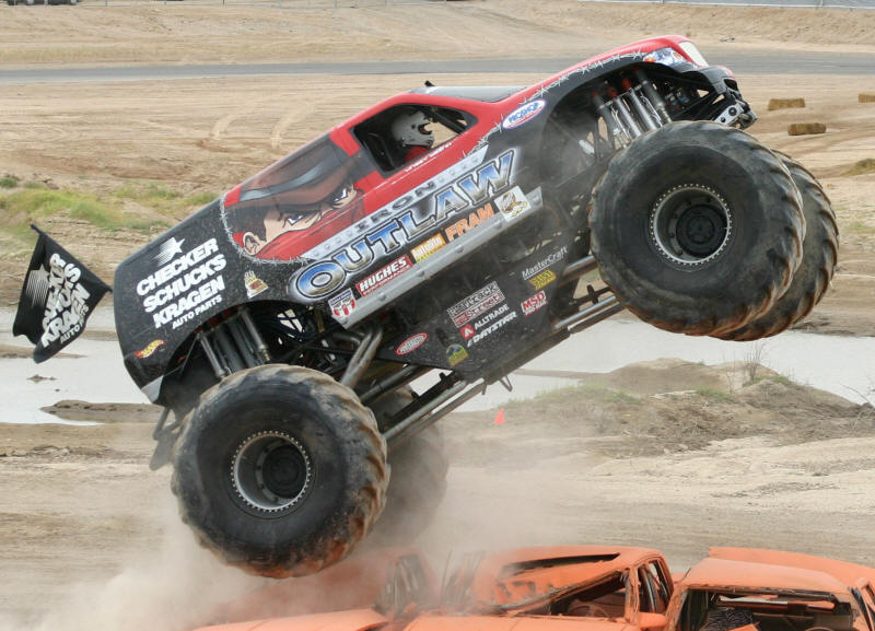 Iron Outlaw Monster Truck takes to the air jumping the cars in this race