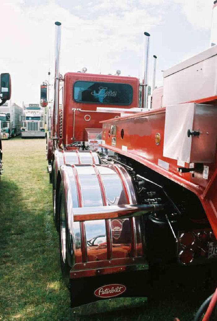 Peterbilt day cab with specialized trailer for moving heavy equipment and large machines on display at Fergus Truck Show