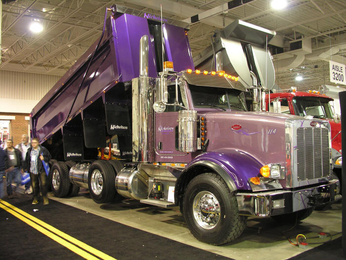 Shiny new purple Peterbilt dump truck at Toronto Truck World
