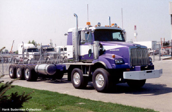 Purple Western Star truck with dual steer axles