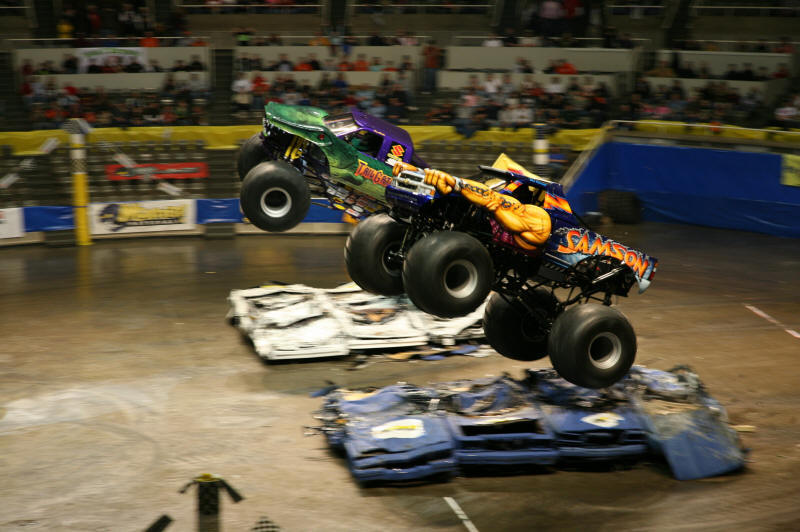 Samson and Tail-Gator Monster trucks in the air together