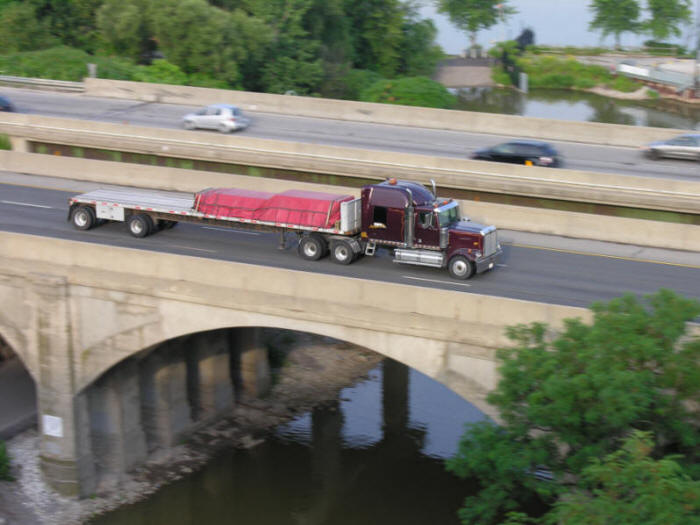 Western Star Highway Tractor with flatbed trailer crossing a bridge passing Cootes Paradise in Hamilton Canada