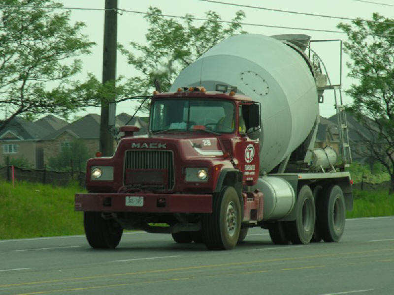 Photo of Mack Truck cement mixer driving around in the suburbs