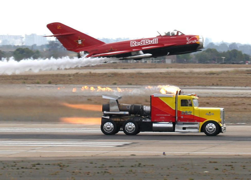 Les Shockley's triple engine Shockwave jet truck whizzes past the3 Red Bull jet